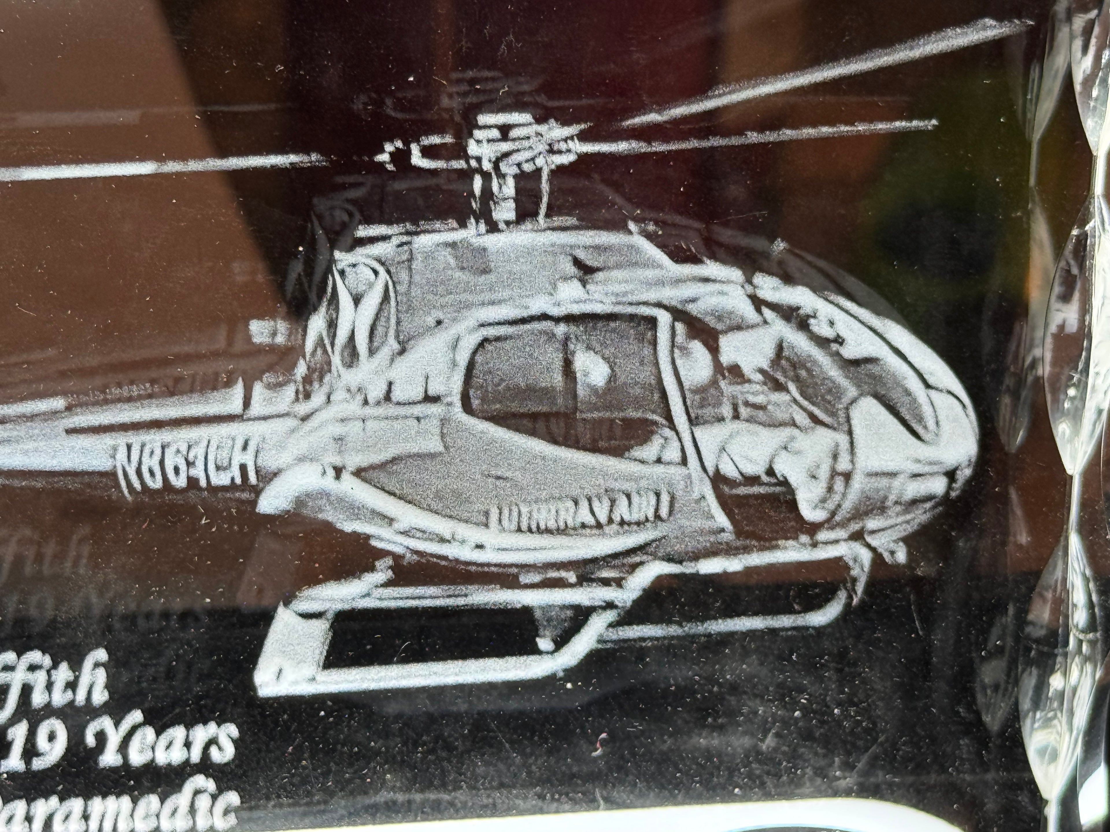 Macro detail of personalized engraved tribute text on 3D crystal

