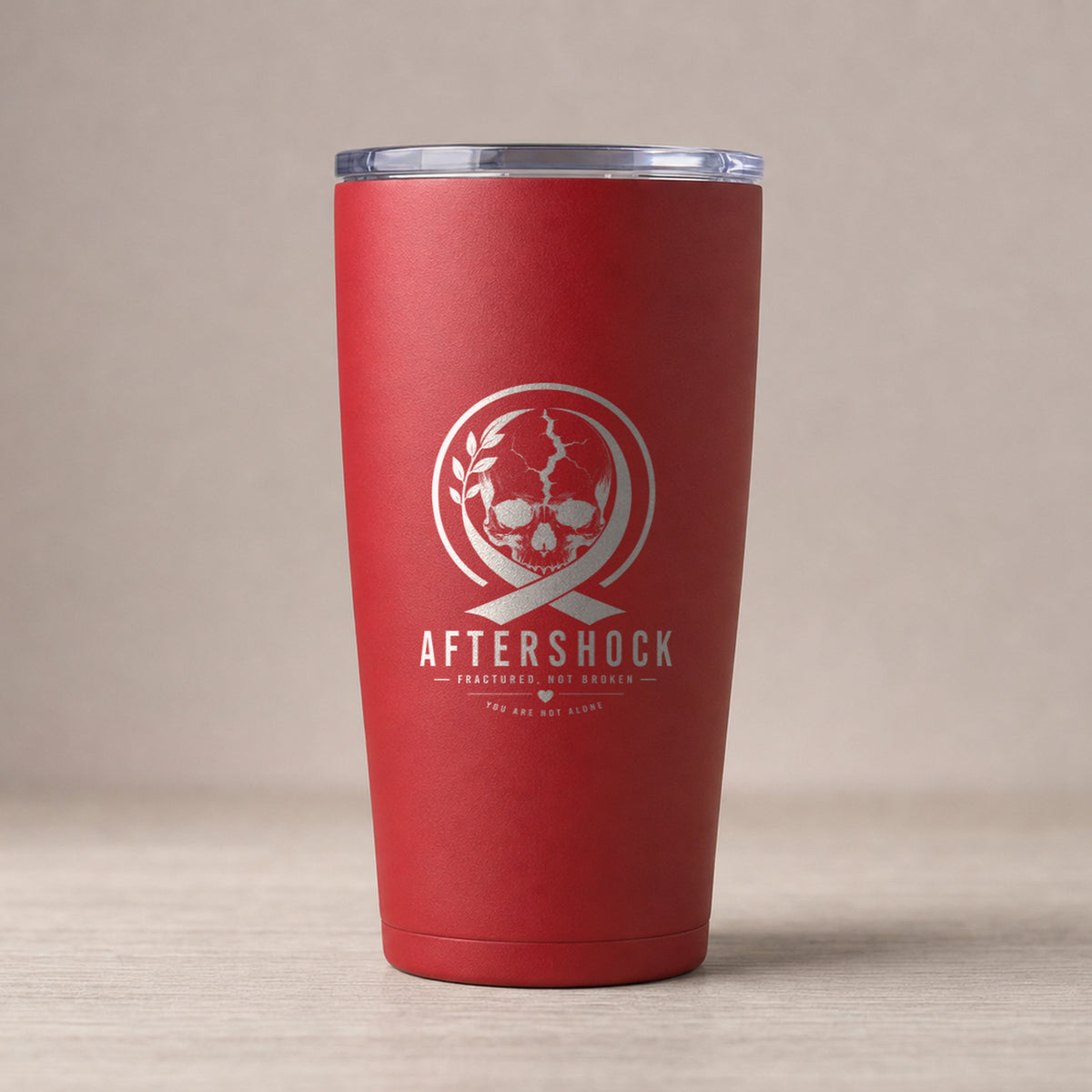 Red insulated stainless tumbler laser engraved with the Aftershock logo